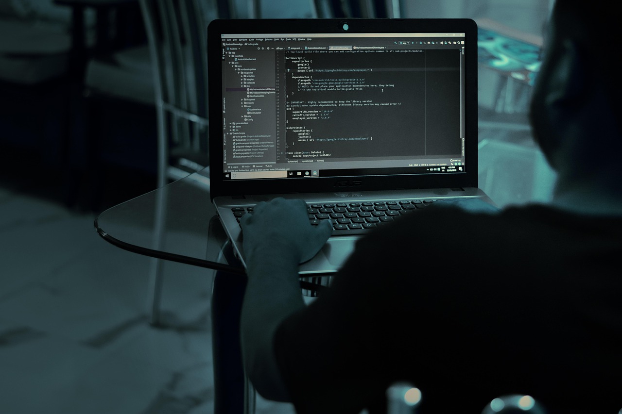 developer typing code laptop