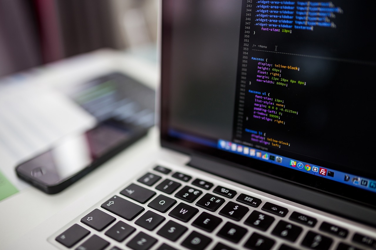 developer typing code laptop