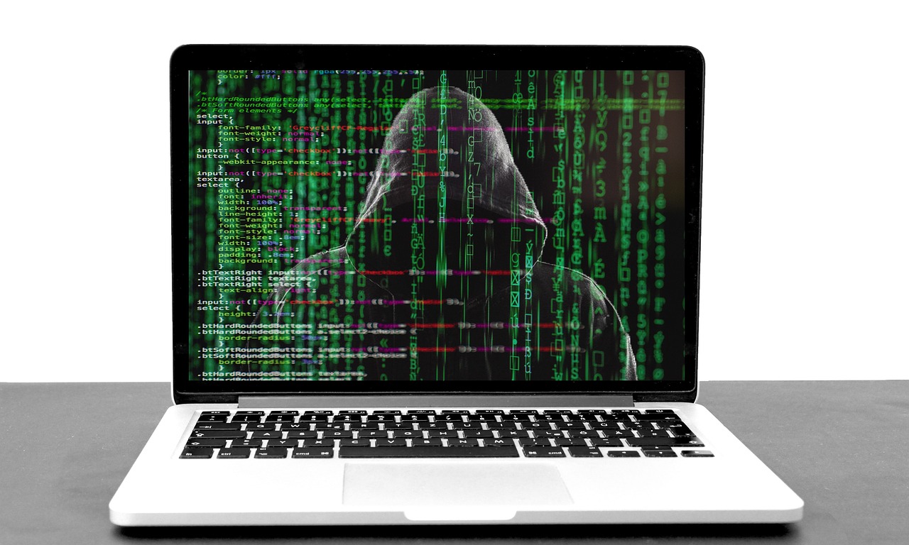 developer typing code laptop