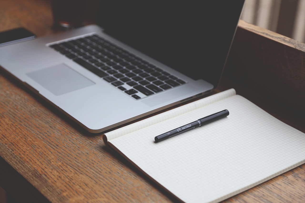 laptop desk with productivity apps on screen